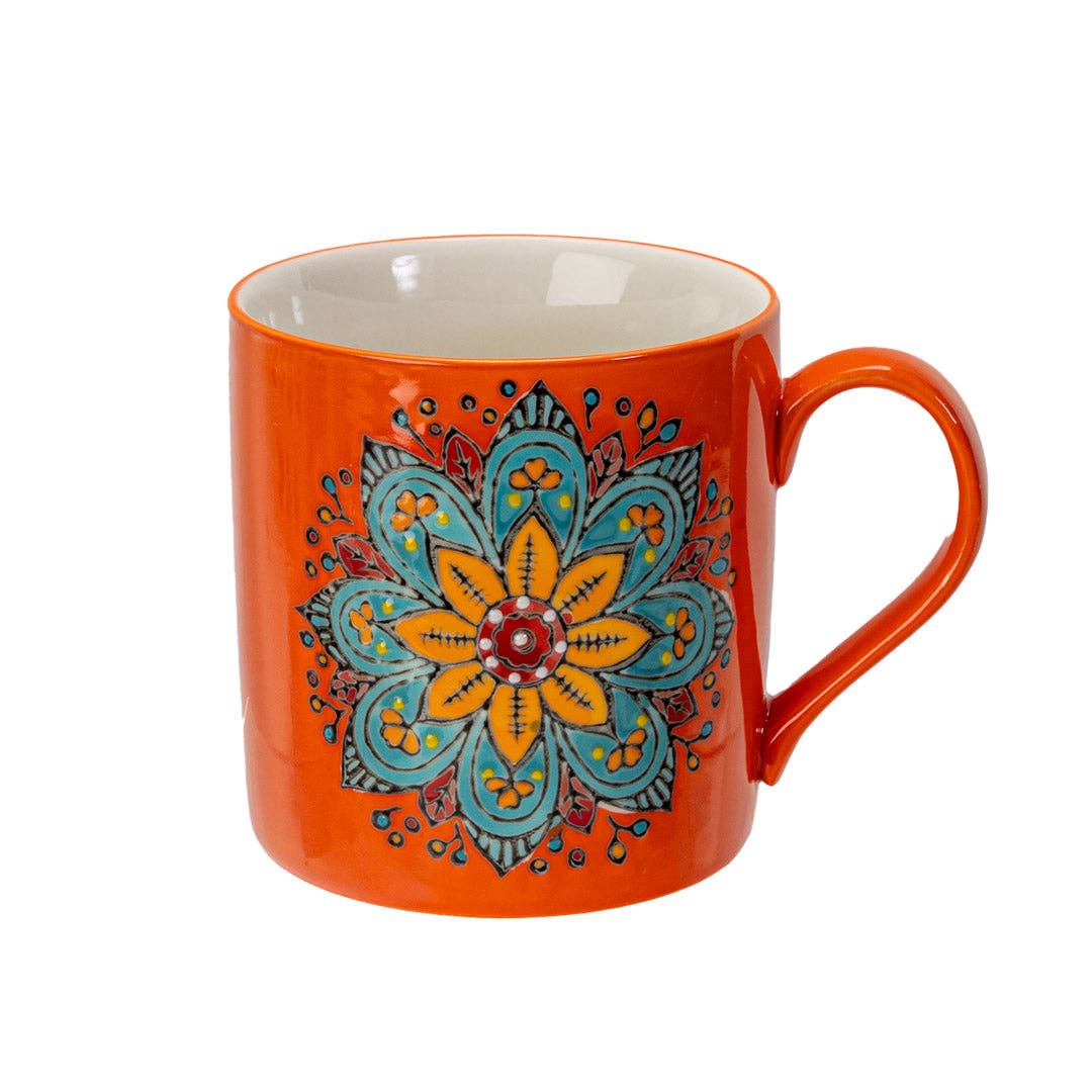 Orange mug with a colorful floral design on a white background