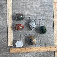 Set of various stones on a grid with measurement ruler