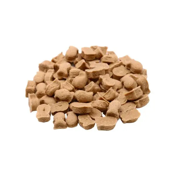 Pile of small brown fish shaped cat treats on a white background 