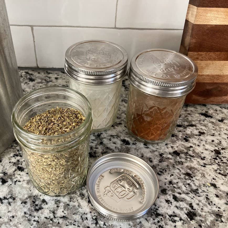 Three glass jars with metal lids on a kitchen counter