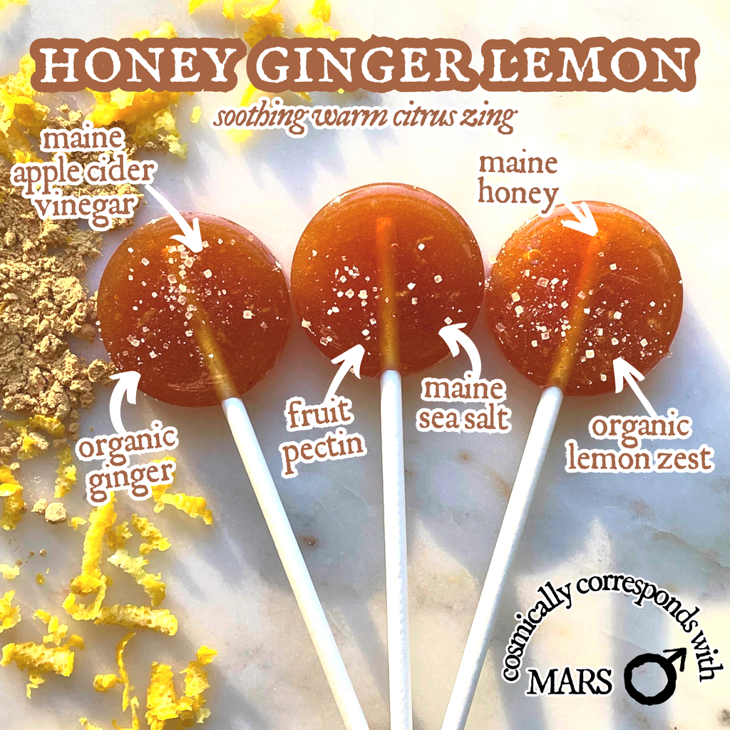 Three honey ginger lemon lollipops with labeled ingredients on a textured background.