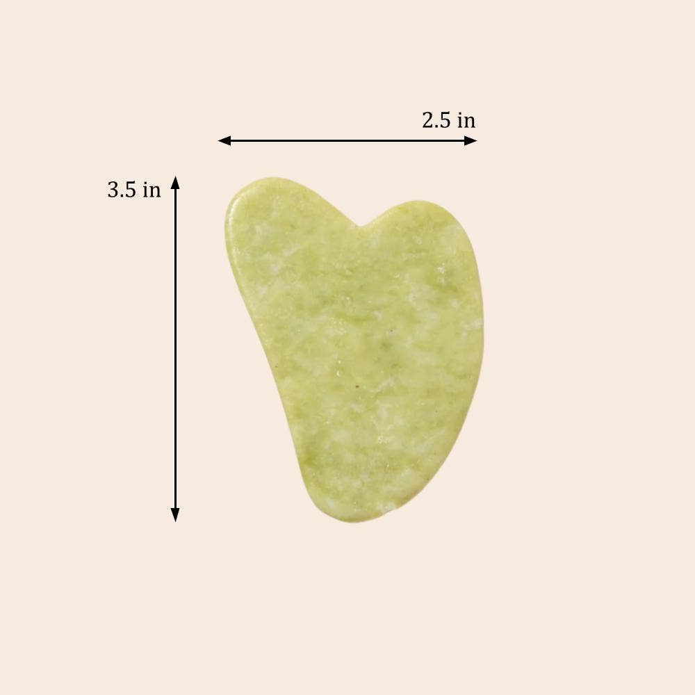Heart-shaped green stone with measurements on a beige background