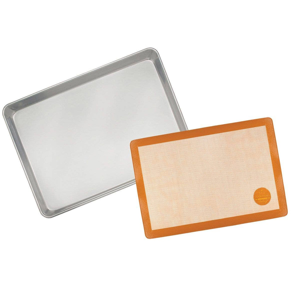 Baking tray and silicone baking mat on a white background