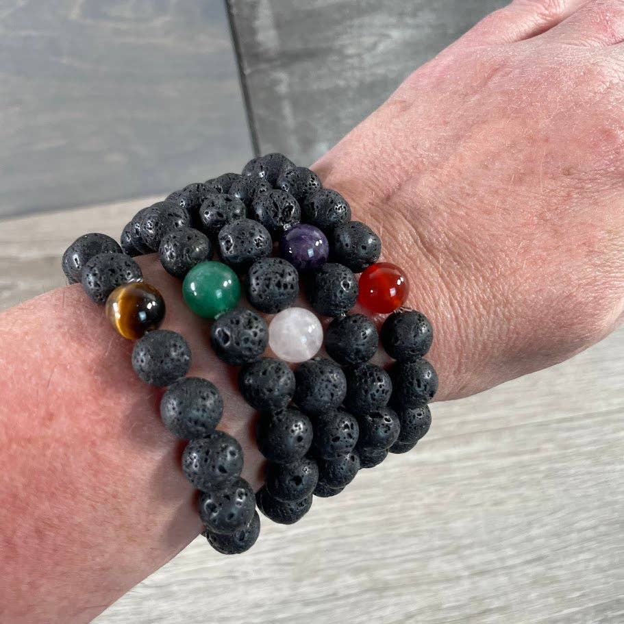 Black beaded bracelet with colorful beads on a wrist against a neutral background