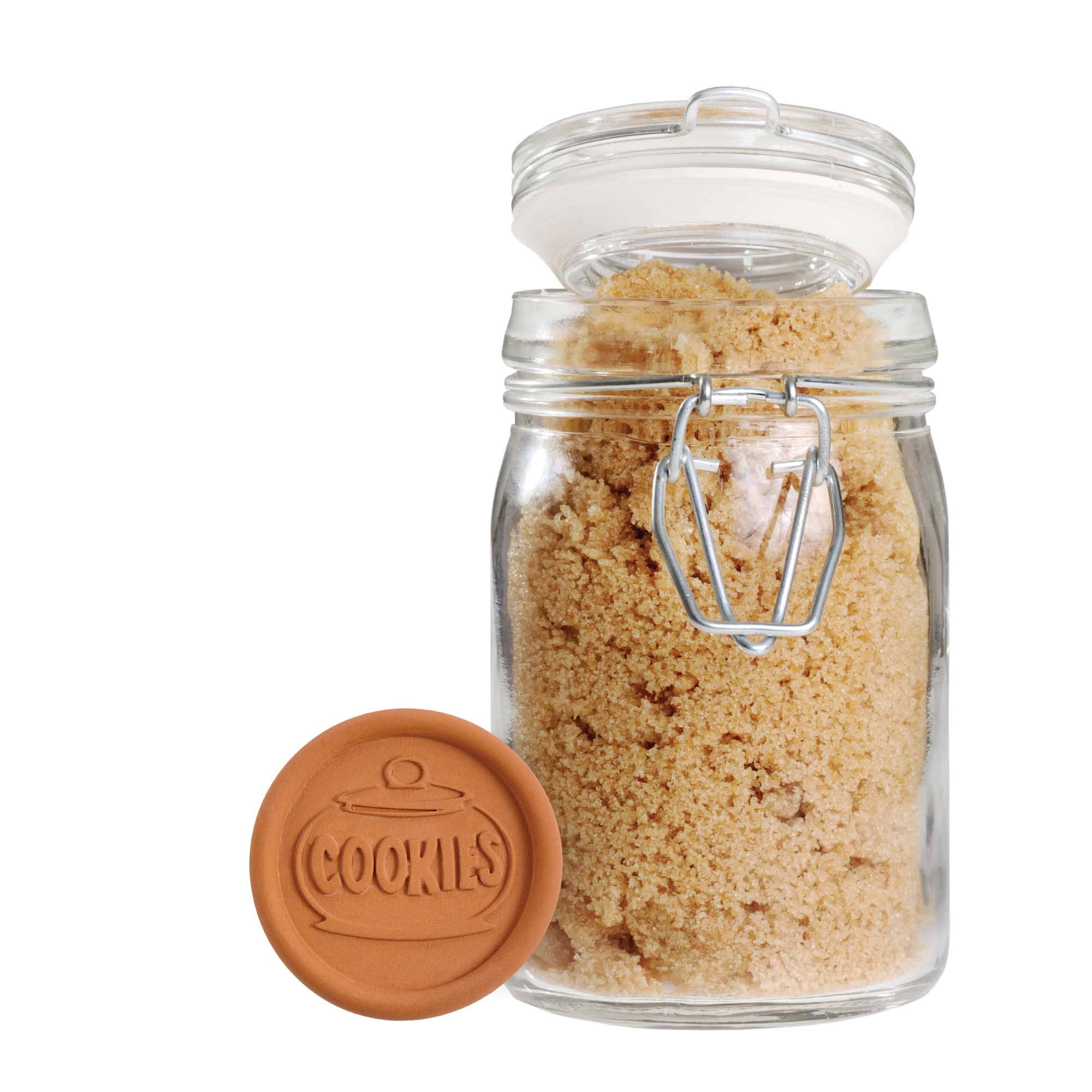 Glass jar with brown sugar and a matching lid on a white background