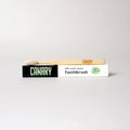 Canary toothbrush with packaging on a light gray background