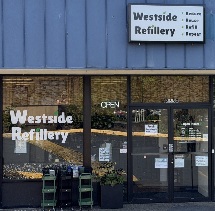Westside Refillery store front with blue roof and glass windows.